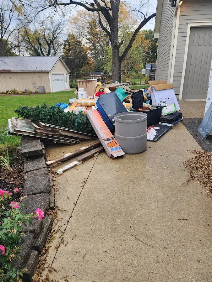 Dumpster being loaded with debris for Estate Cleanout Dumpster Rental in Herrin